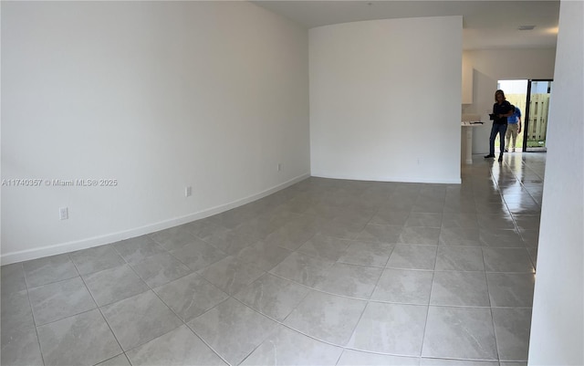 empty room with light tile patterned floors