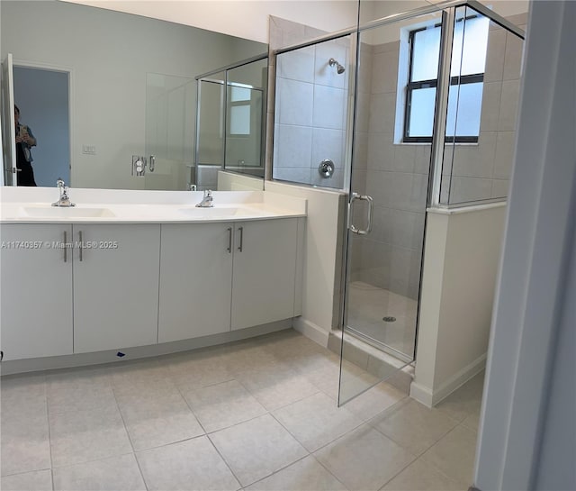 bathroom featuring vanity, tile patterned flooring, and a shower with shower door