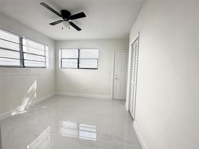 unfurnished bedroom featuring ceiling fan and a closet