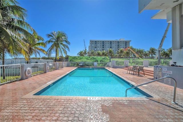 view of swimming pool featuring a patio area