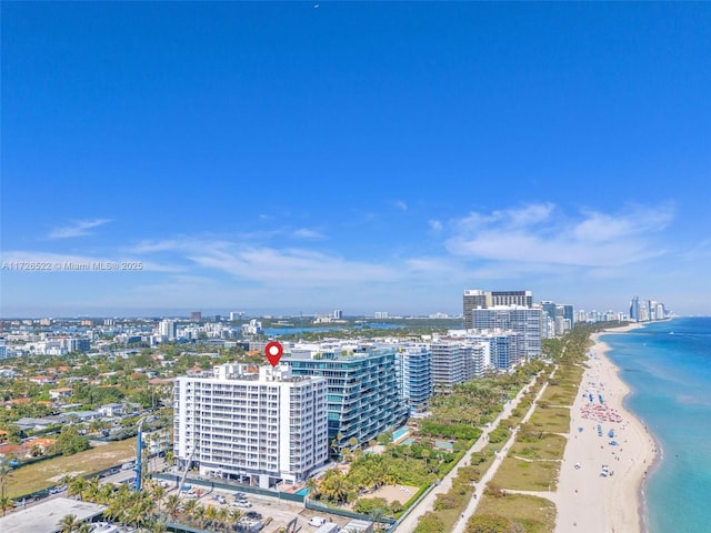 birds eye view of property featuring a beach view and a water view