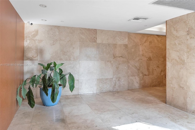 bathroom with tile walls