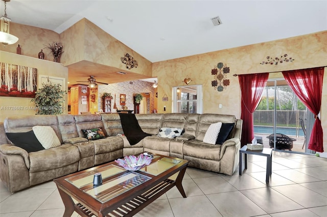 tiled living room with high vaulted ceiling and ceiling fan