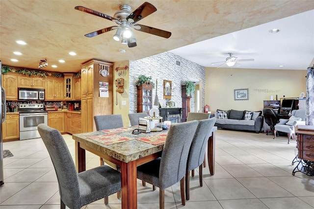 tiled dining area featuring ceiling fan