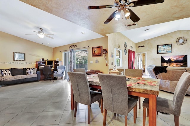 tiled dining area with lofted ceiling and ceiling fan