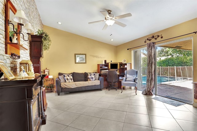 living room with vaulted ceiling, light tile patterned floors, and ceiling fan