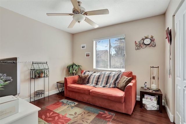 living room with dark wood-type flooring and ceiling fan