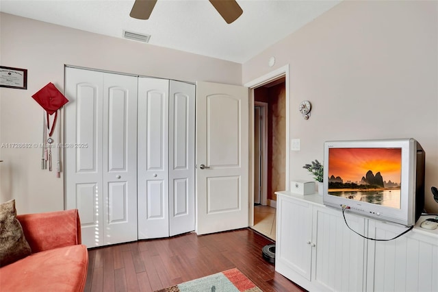 interior space with dark wood-type flooring and ceiling fan