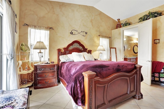 tiled bedroom featuring lofted ceiling and ensuite bathroom