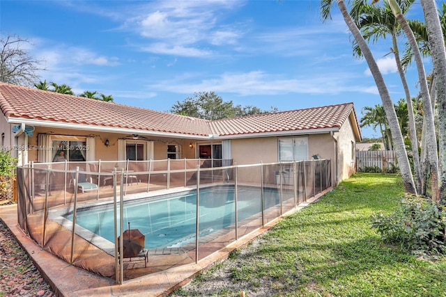 view of swimming pool featuring a yard, ceiling fan, and a patio area