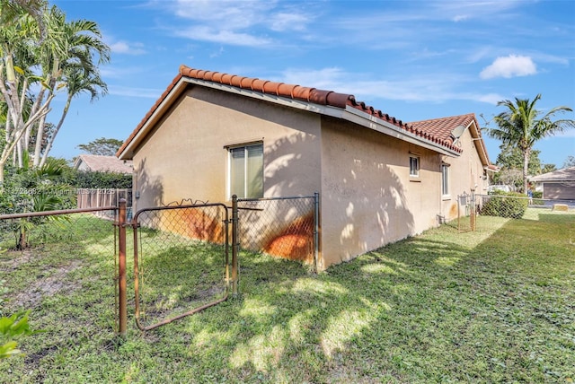 view of side of home featuring a yard