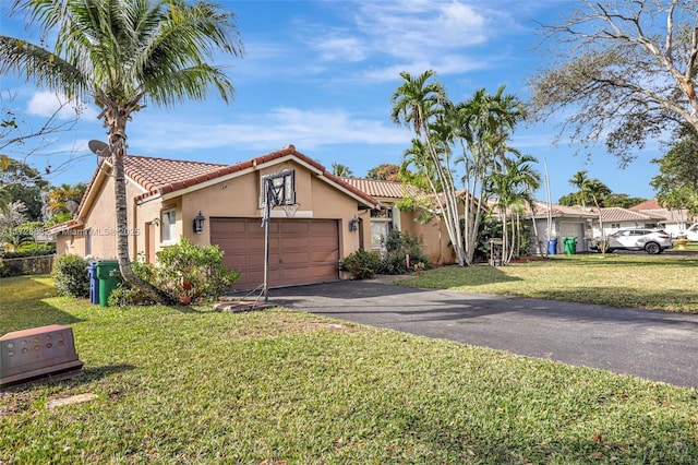 mediterranean / spanish-style house featuring a garage and a front yard