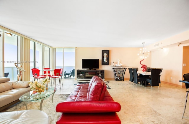 living room with a notable chandelier and expansive windows