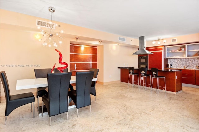 dining room with indoor bar and a notable chandelier