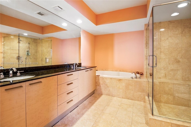 bathroom featuring vanity, shower with separate bathtub, and a raised ceiling