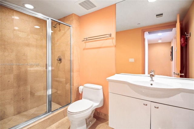 bathroom featuring walk in shower, vanity, tile patterned floors, and toilet