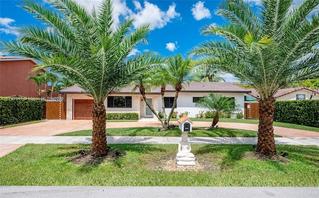 view of front facade featuring a garage and a front lawn