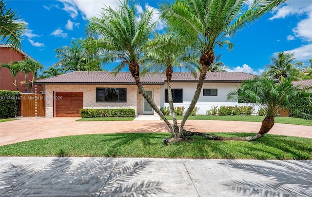 view of front of property with a garage and a front lawn