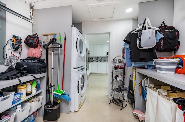 laundry room featuring stacked washer / drying machine