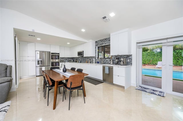 dining area featuring lofted ceiling