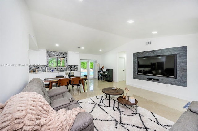 living room with lofted ceiling and sink