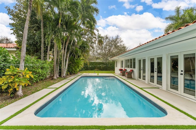 view of pool featuring french doors