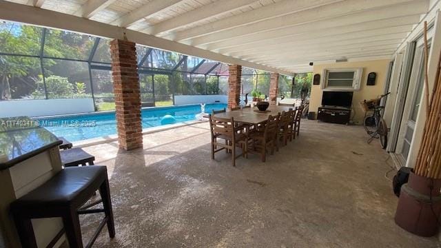 view of patio featuring glass enclosure