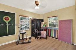 living area with hardwood / wood-style floors and ceiling fan