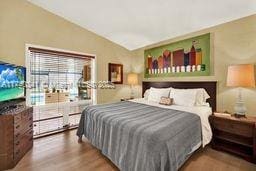 bedroom featuring lofted ceiling and hardwood / wood-style floors