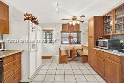 kitchen with track lighting and light tile patterned flooring