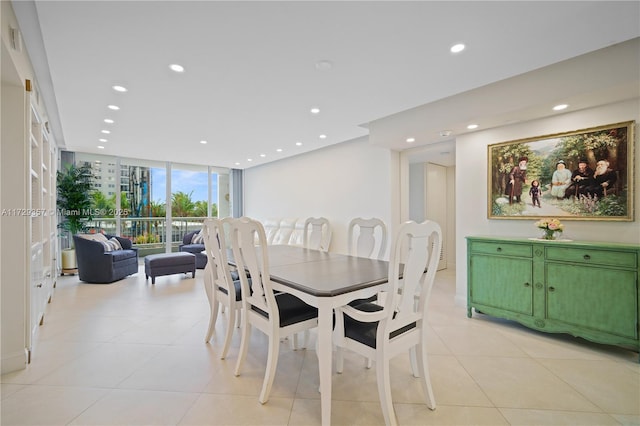 tiled dining space featuring expansive windows