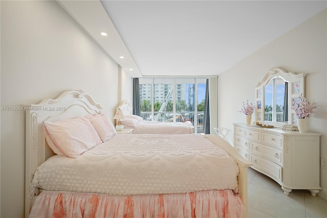 tiled bedroom with multiple windows, access to exterior, and floor to ceiling windows