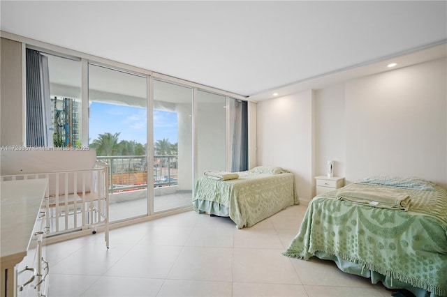 bedroom featuring floor to ceiling windows, light tile patterned floors, and access to outside