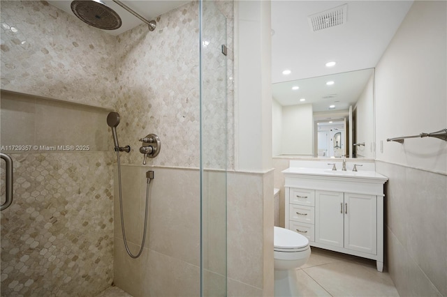 bathroom featuring tile patterned floors, toilet, an enclosed shower, and vanity