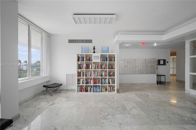 unfurnished room featuring a mail area