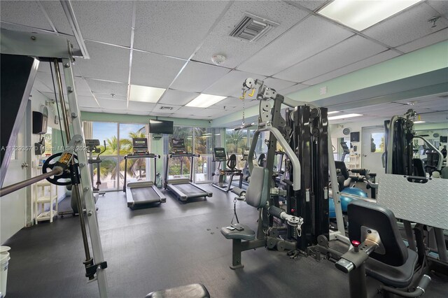 exercise room featuring a drop ceiling