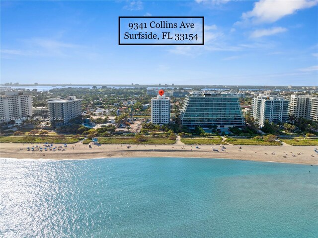 drone / aerial view with a water view and a view of the beach