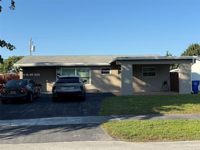 single story home featuring a carport and a front lawn