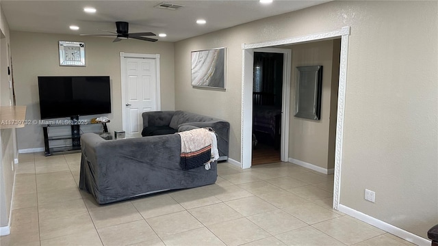 living room with light tile patterned floors and ceiling fan