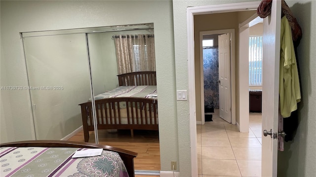 bedroom with a closet and light tile patterned floors