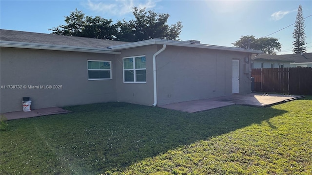 back of property with a patio and a lawn