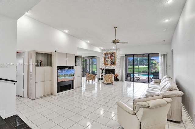 living room with light tile patterned floors, a large fireplace, ceiling fan, high vaulted ceiling, and recessed lighting