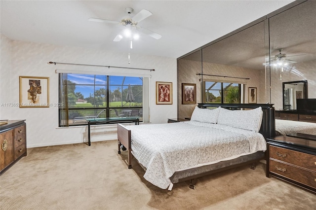 bedroom featuring light carpet and baseboards