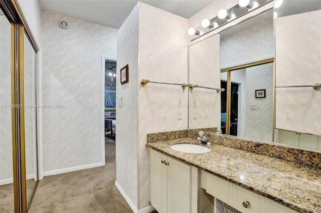 bathroom featuring baseboards and vanity