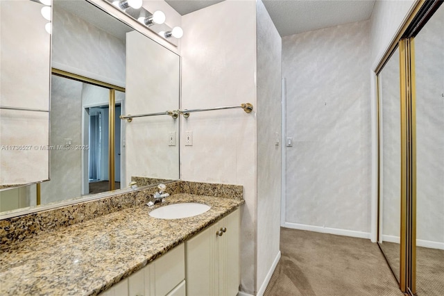 bathroom with vanity and baseboards