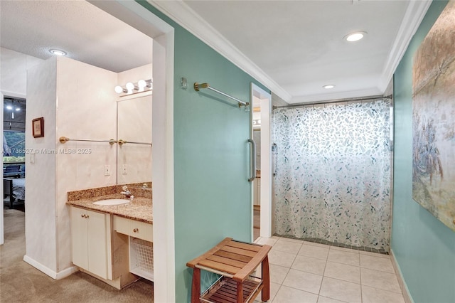 full bathroom featuring curtained shower, vanity, baseboards, ornamental molding, and tile patterned floors