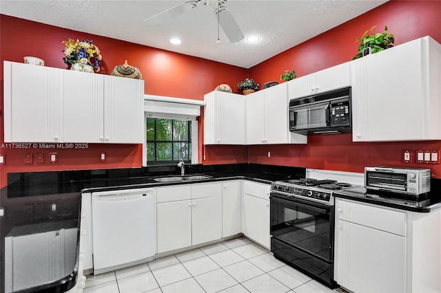 kitchen featuring dark countertops, white cabinets, a sink, and black appliances