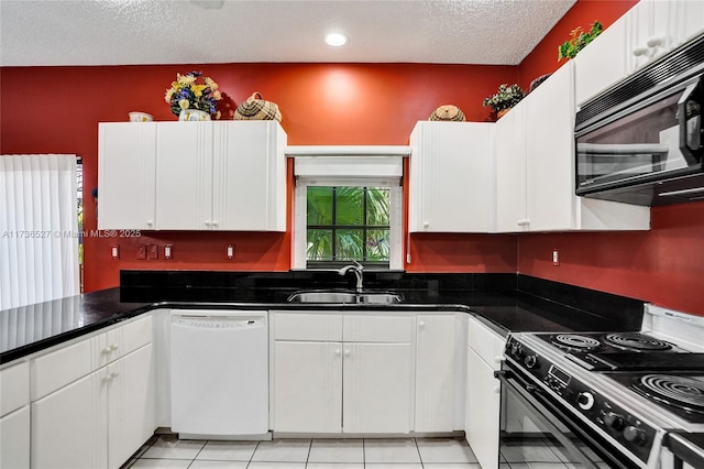 kitchen featuring black appliances, a textured ceiling, white cabinetry, and a sink