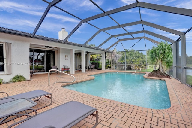 outdoor pool with a patio, a lanai, and a ceiling fan