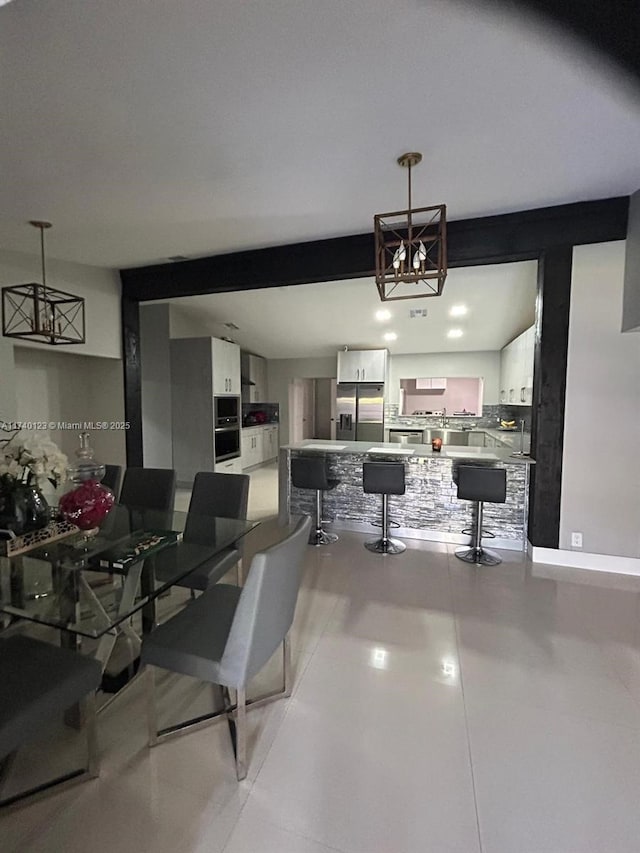 15281 SW 153rd St, Miami, FL 33187 - dining room with beam ceiling, a notable chandelier, and baseboards